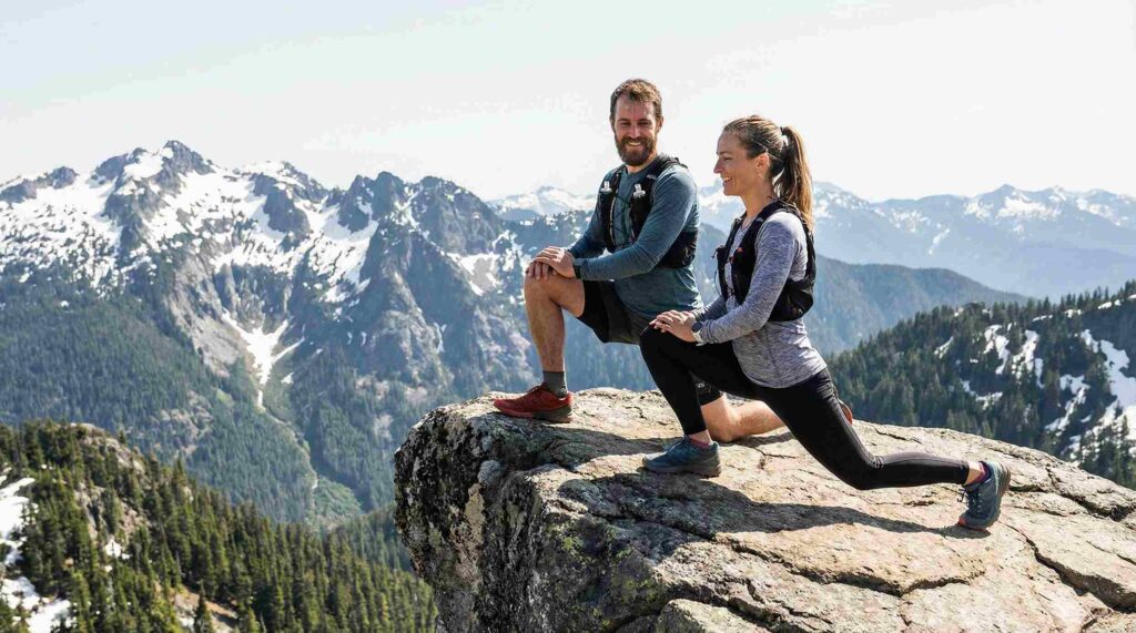 Athletes performing a stretch for athletic recovery